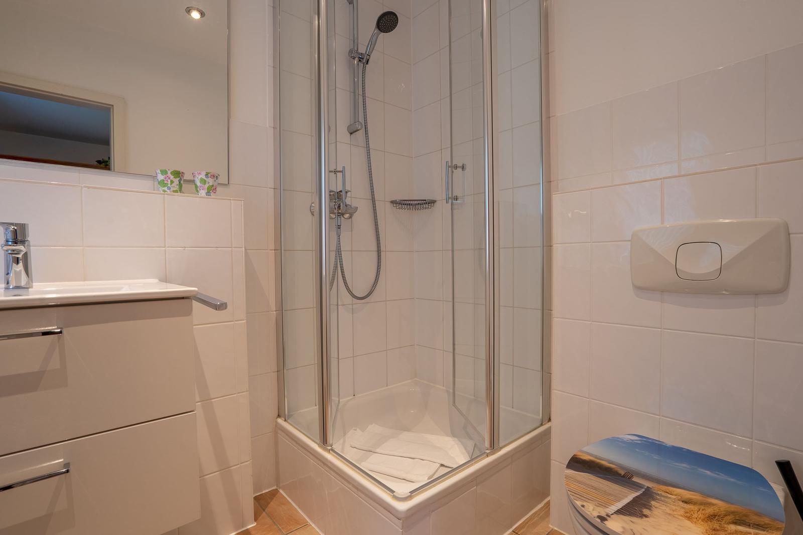 Bathroom with shower, sink, and toilet.