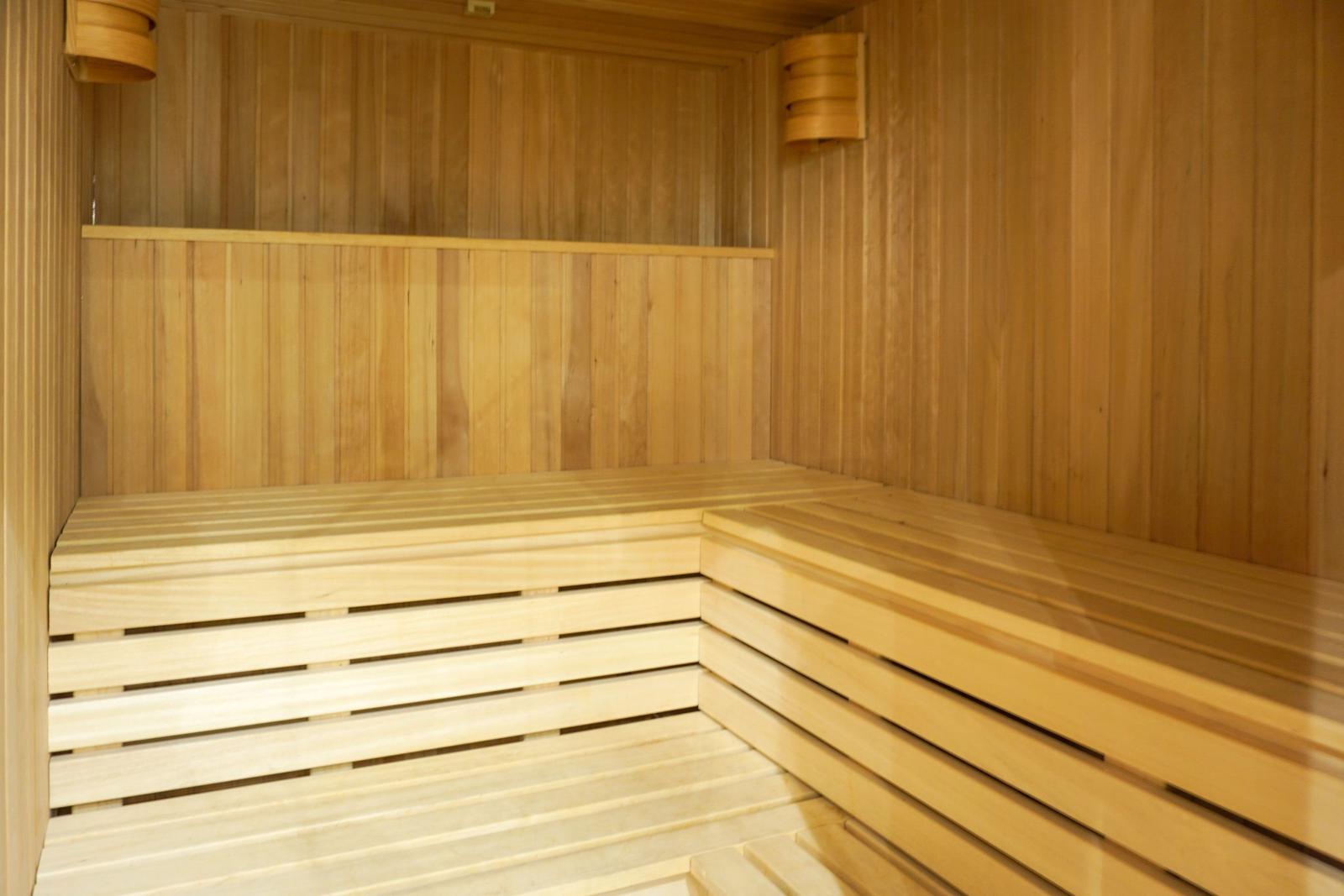 Sauna with wooden bench and wooden wall cladding