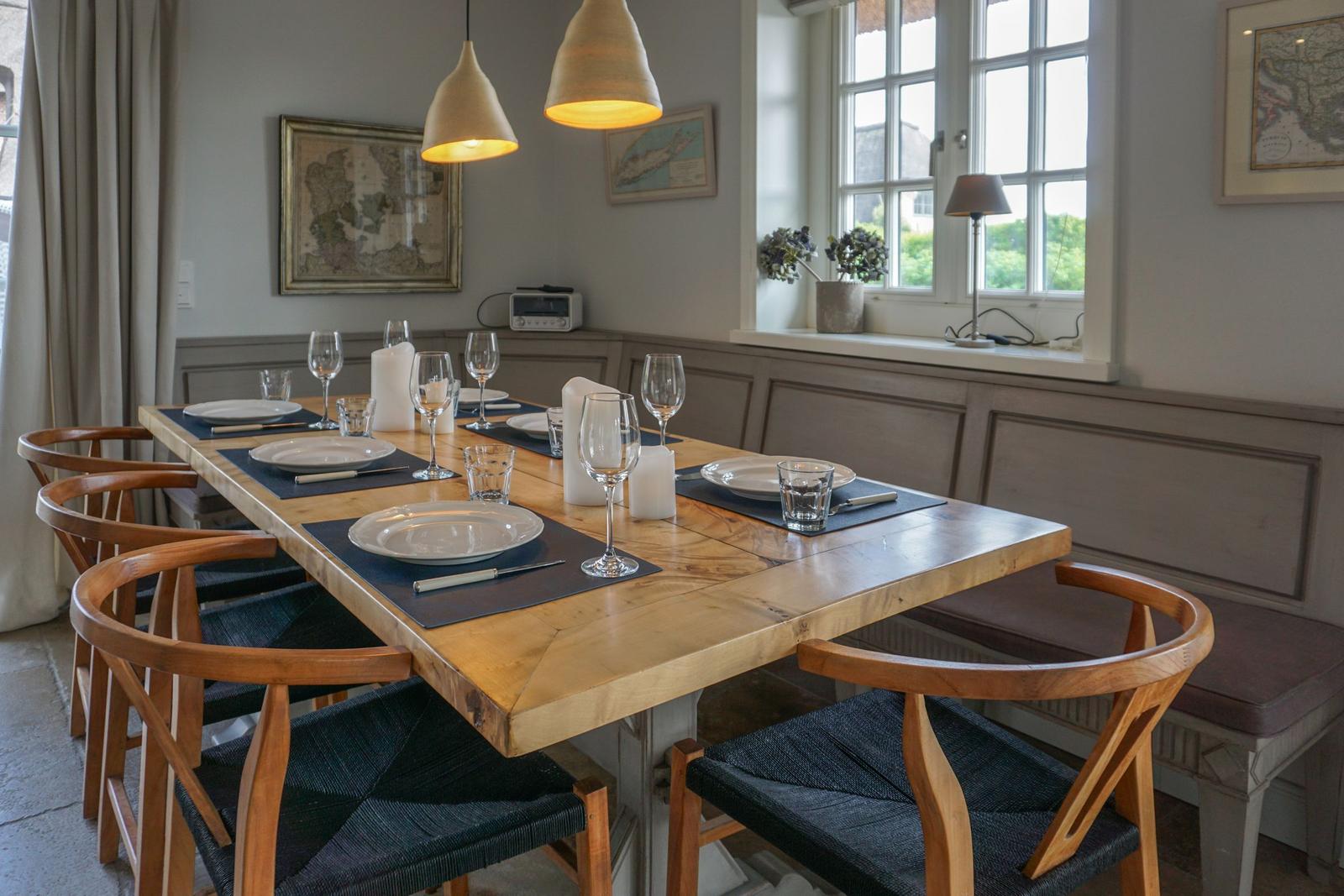 Dining room with wooden table, chairs, and window view