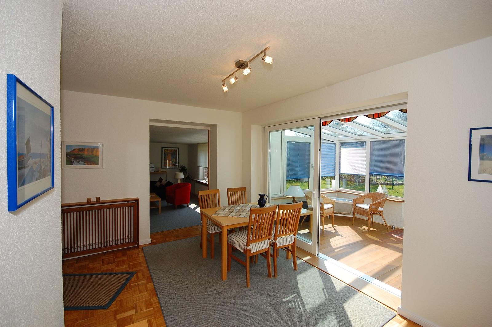 Dining room with table, chairs, and view of terrace.