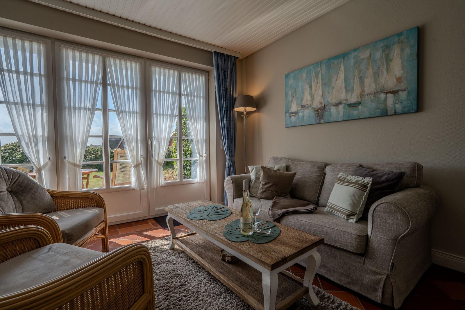 Living room with sofa, coffee table, and garden view.
