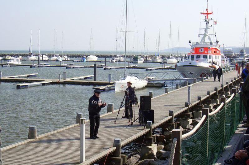 Wooden pier with boats and lifeboat in background
