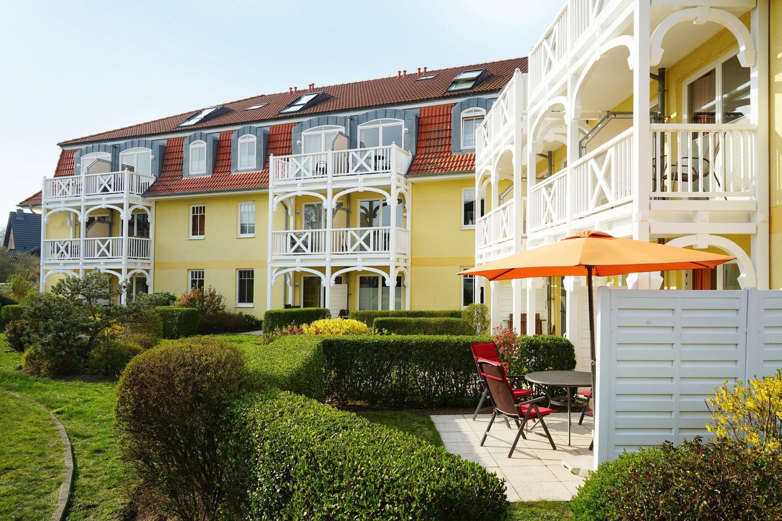 Terrasse mit Gartenmöbeln und Grünfläche