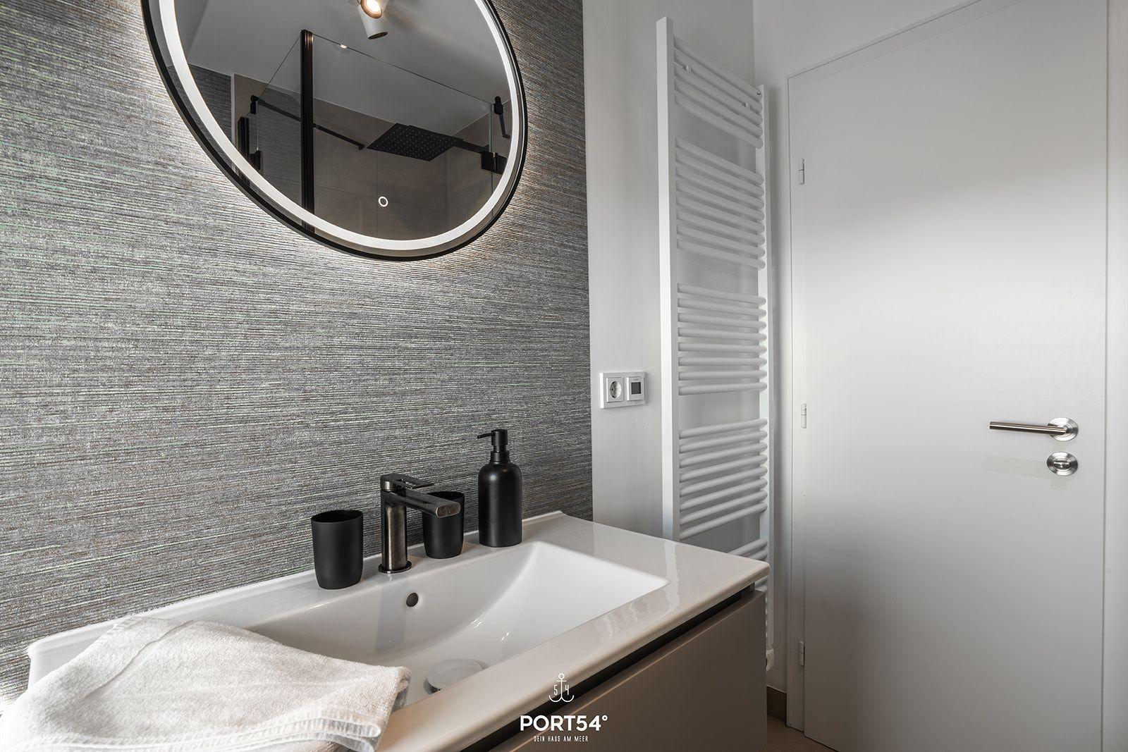 Bathroom with sink, mirror, and heater