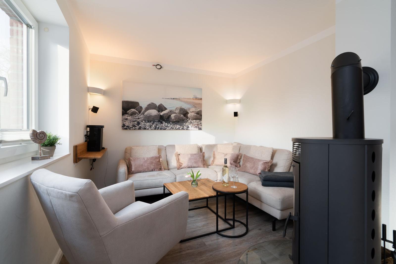 Living room with sofa, armchair, fireplace, and wall art
