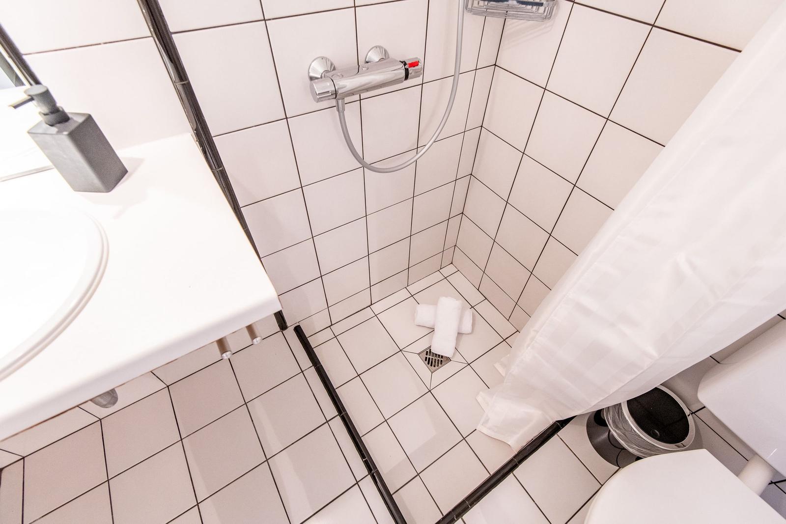 Bathroom with shower, sink, and toilet
