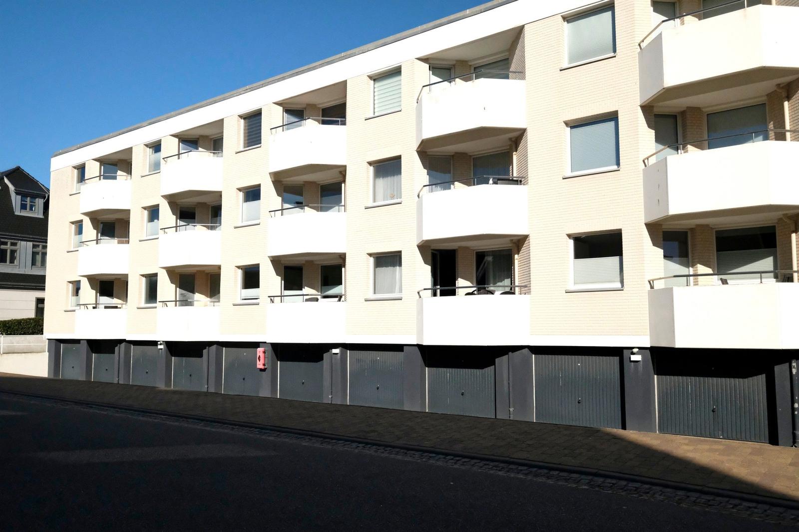 Modern apartment building with balconies and garages