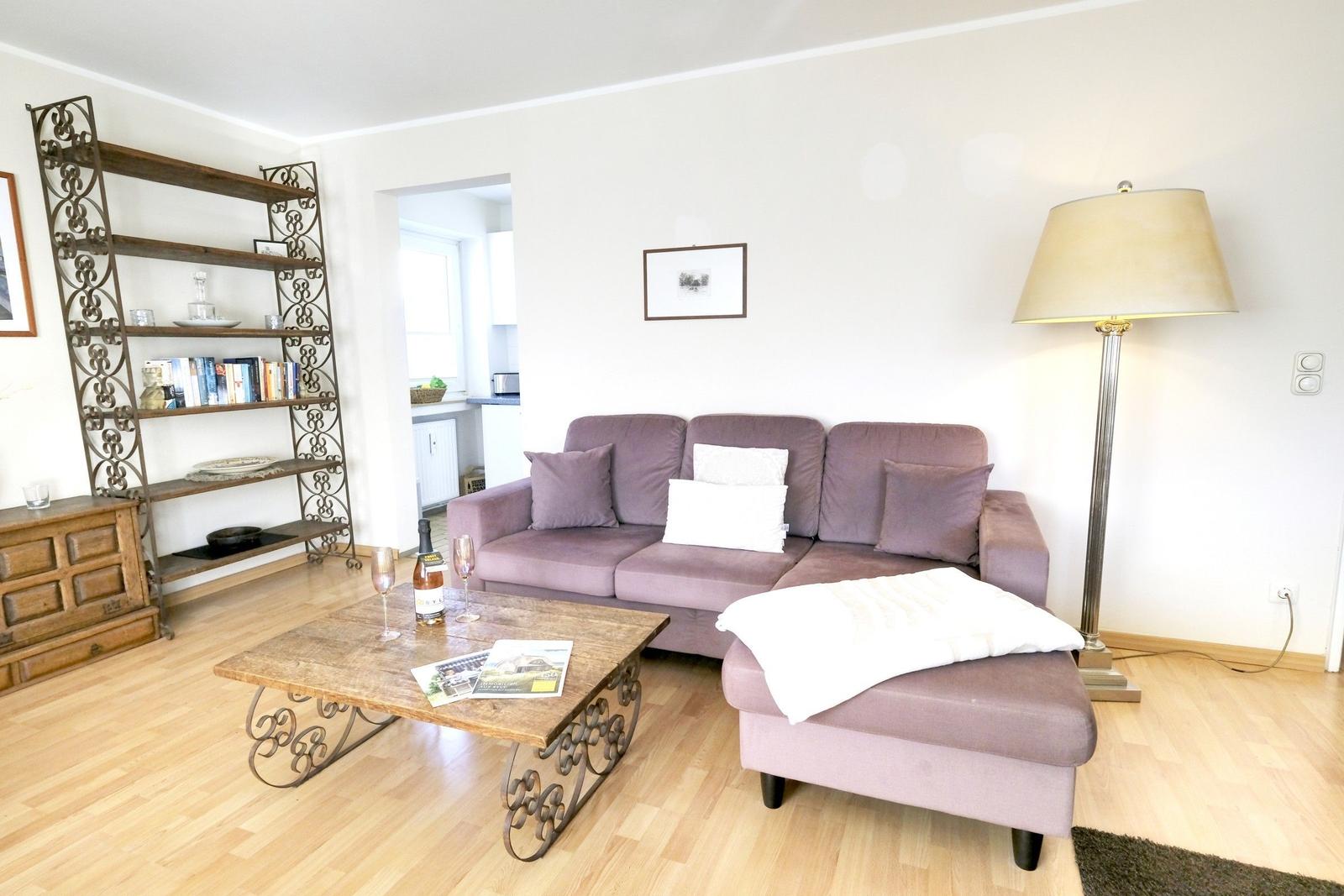 Living room with sofa, coffee table, and floor lamp.