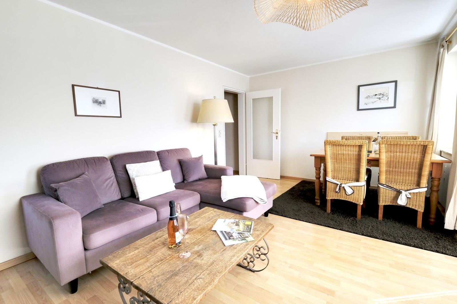 Living and dining area with sofa, table and chairs.