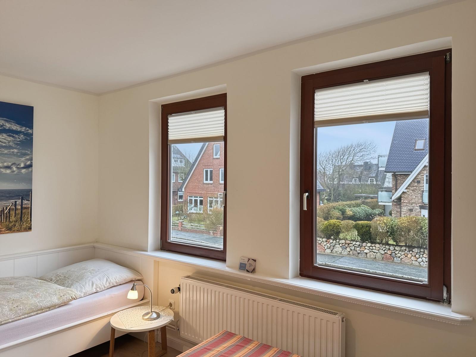 Bedroom with view of garden and house