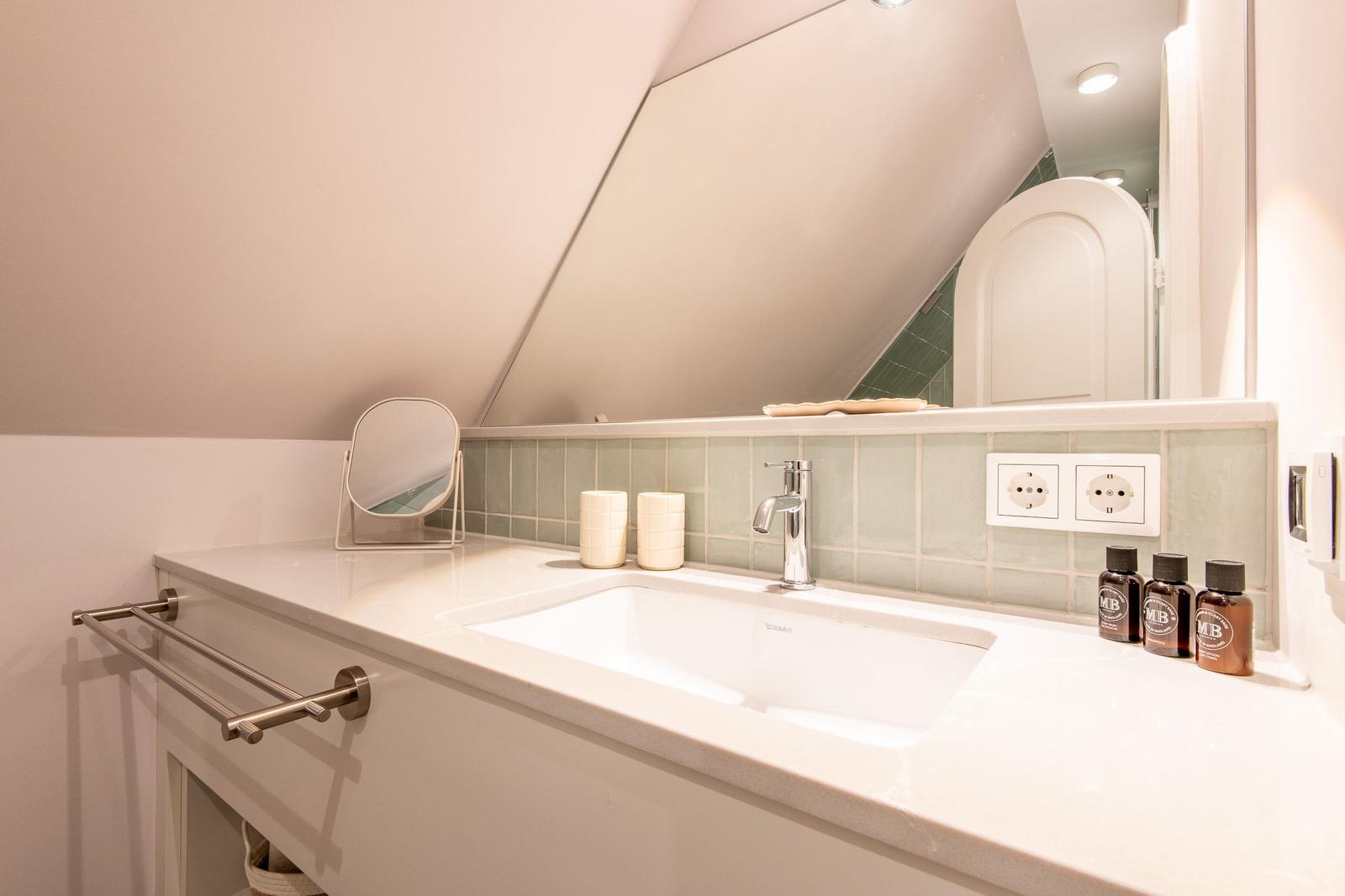 Bathroom with sink, mirror, and towel rack