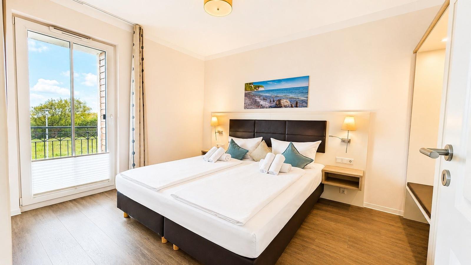 Schlafzimmer mit Doppelbett, Balkon und Wandbild