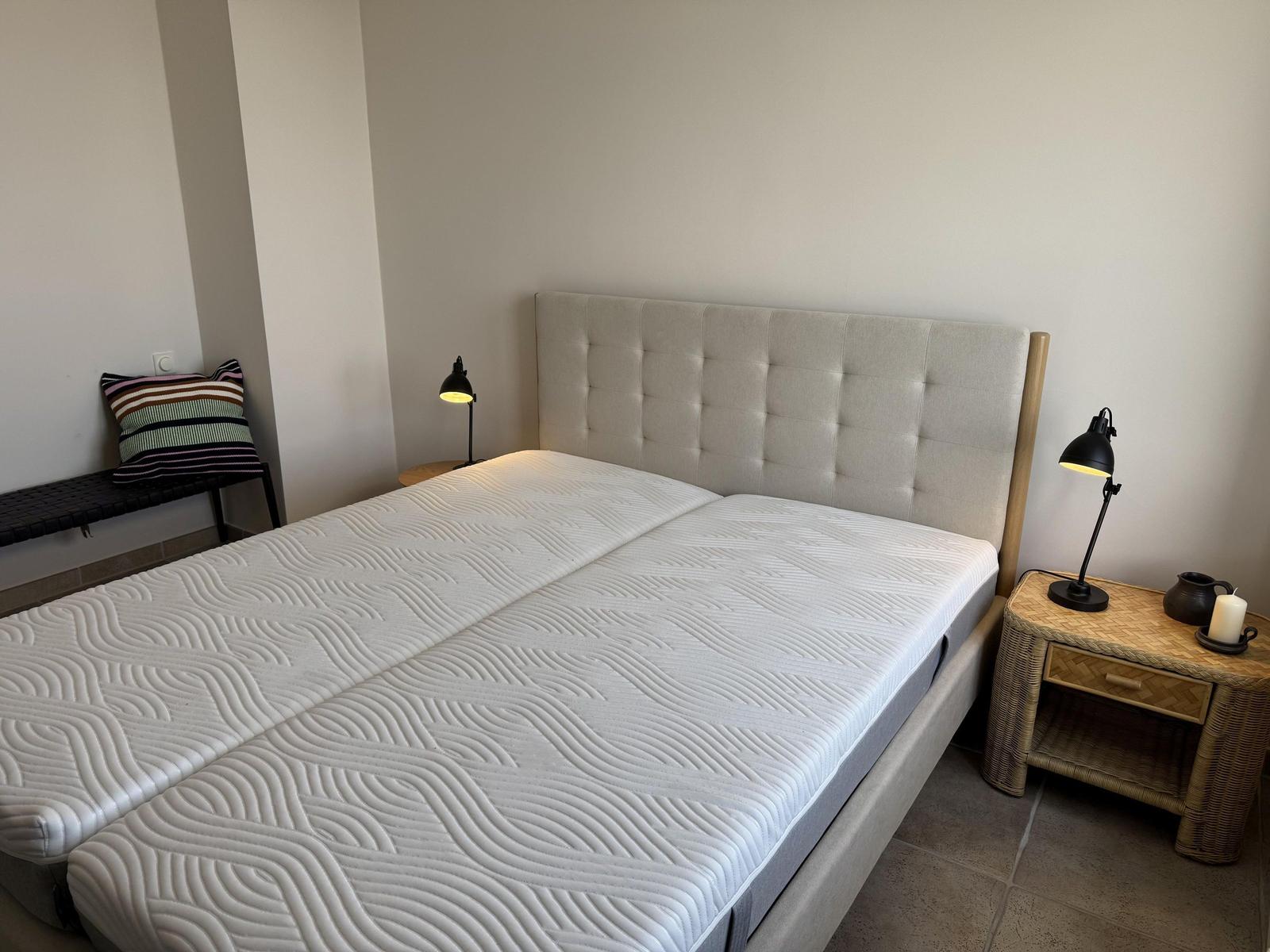 Bedroom with bed, nightstand, and lamp