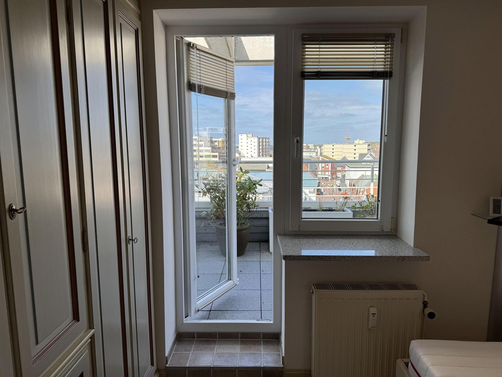 Room with balcony and city view