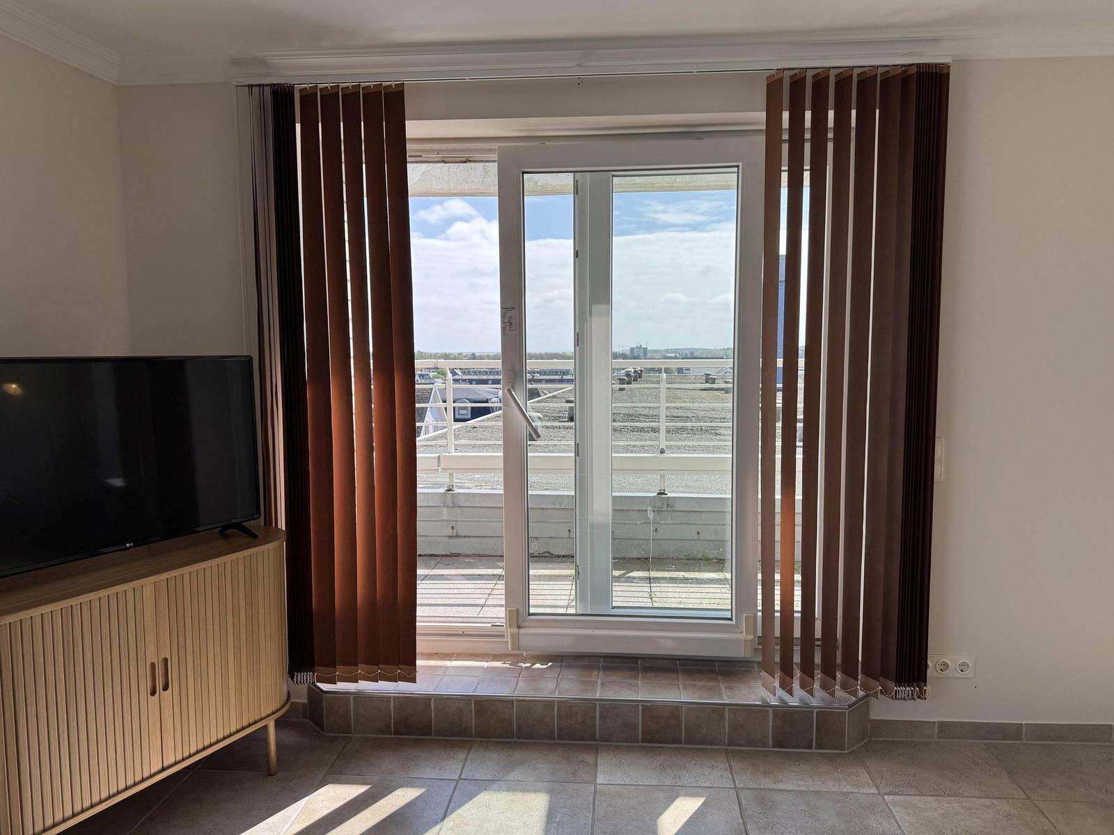 Room with TV and terrace door for view