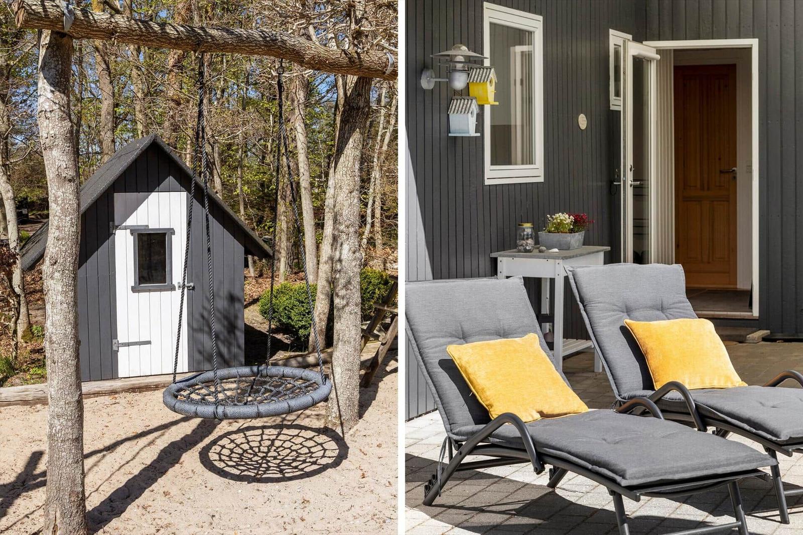 Swing in front of wooden house and lounge chairs with cushions against house wall