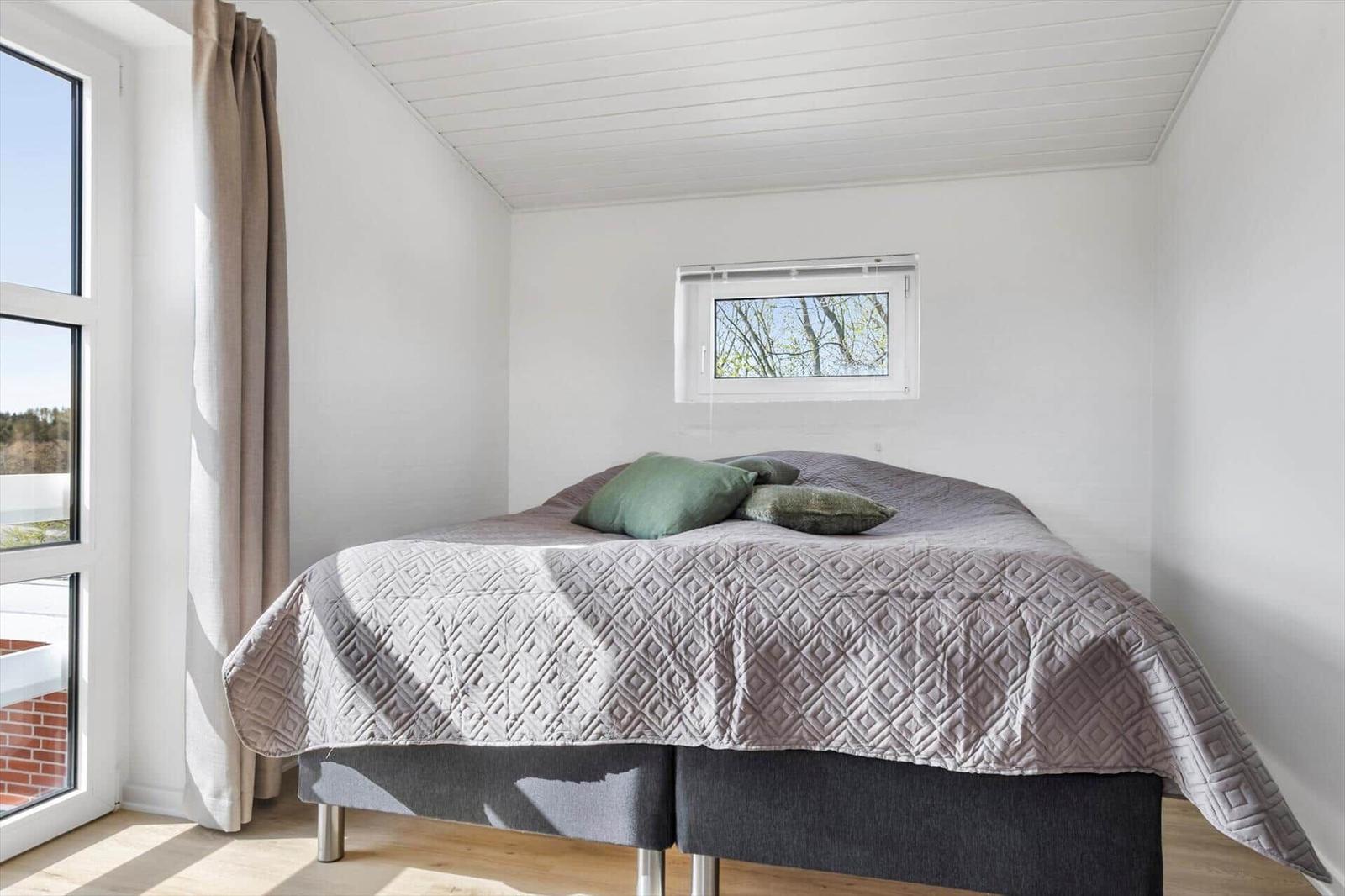 Bedroom with bed, window, and ceiling