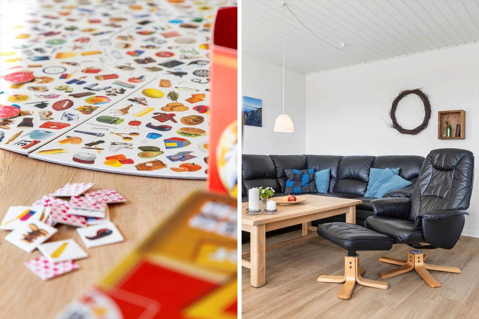 Living room with black leather sofa and wooden table. Toys are on the floor.