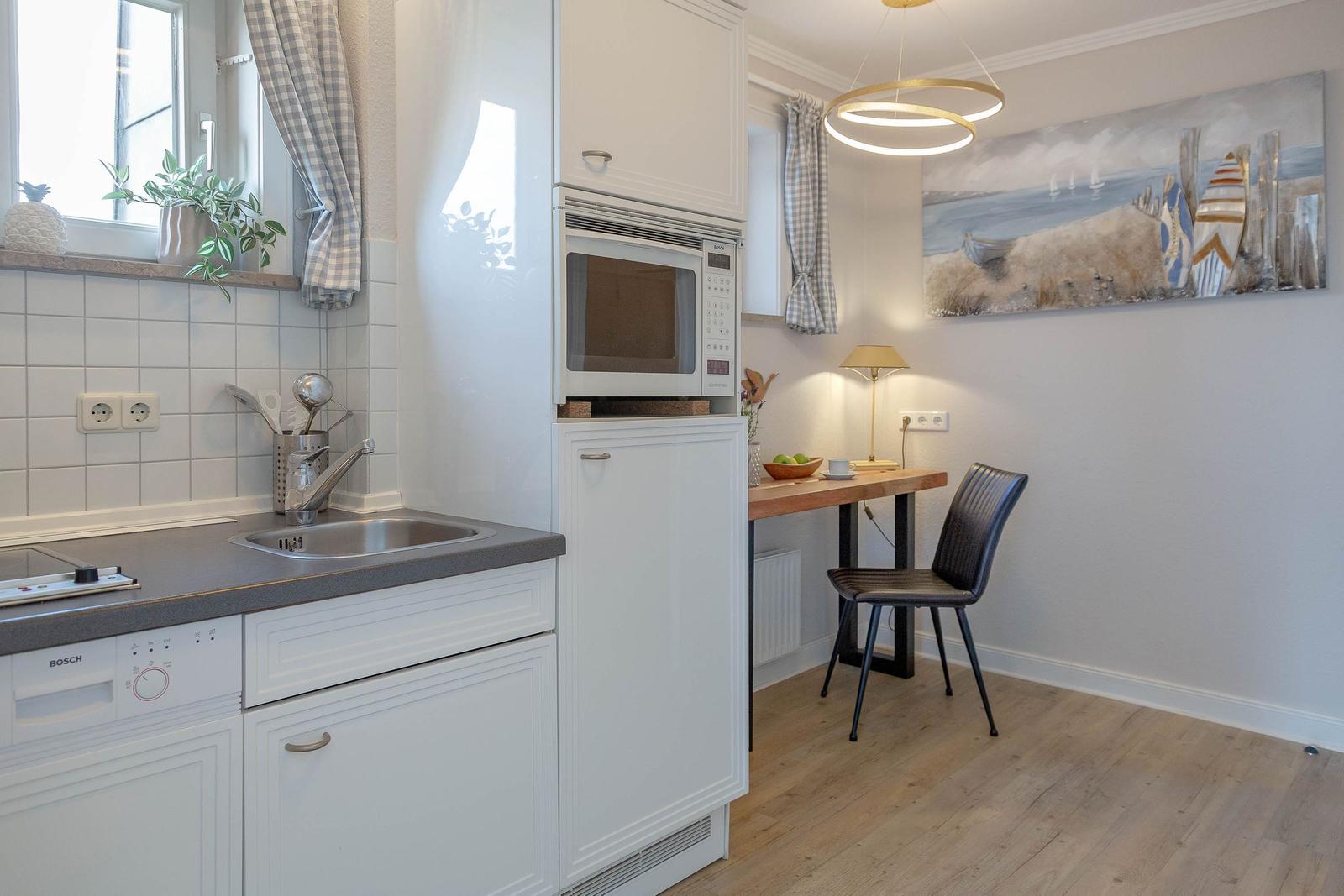 Küche mit Arbeitsplatz, Mikrowelle und Waschbecken