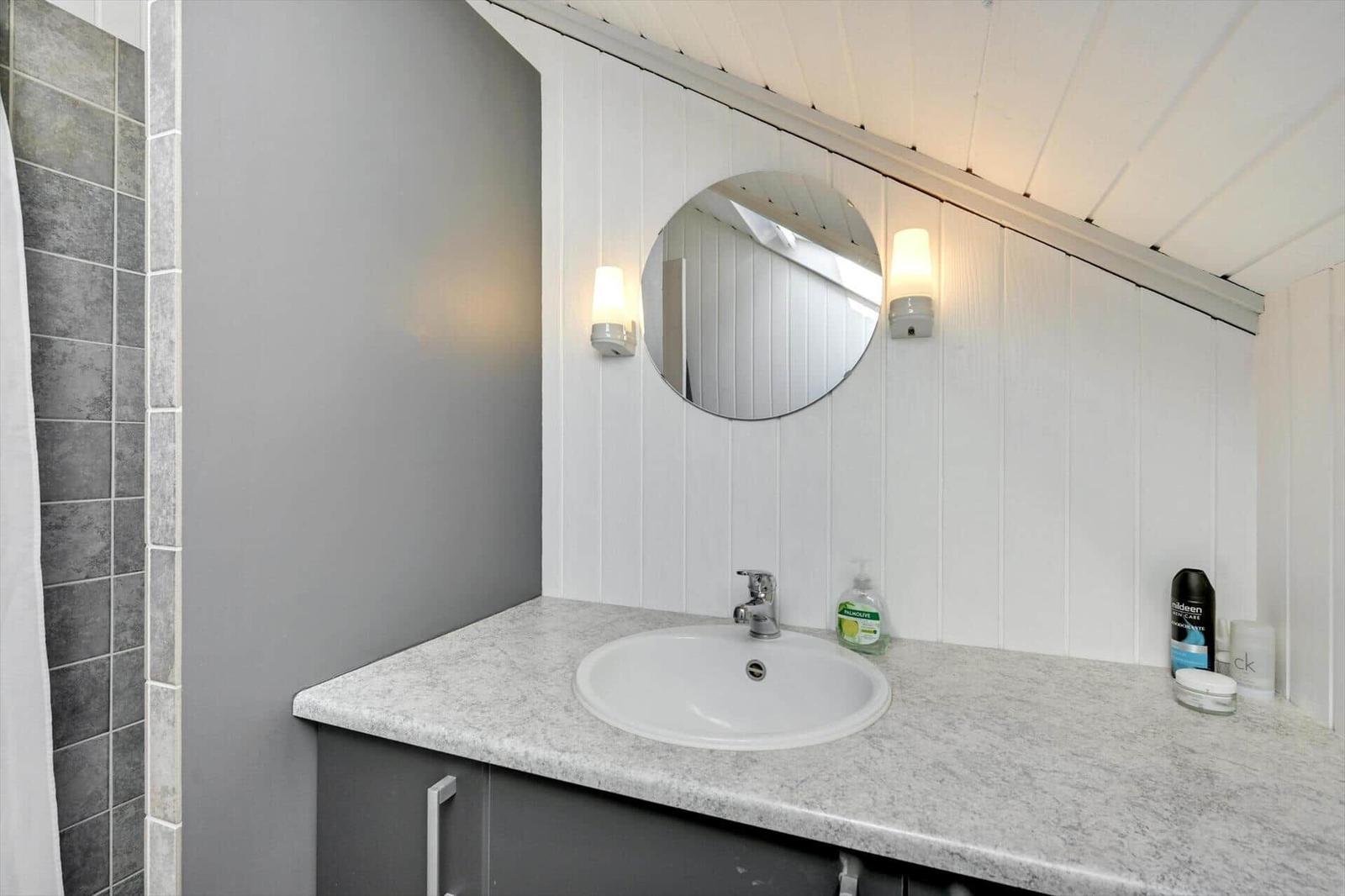 Bathroom with sink, mirror, and shower