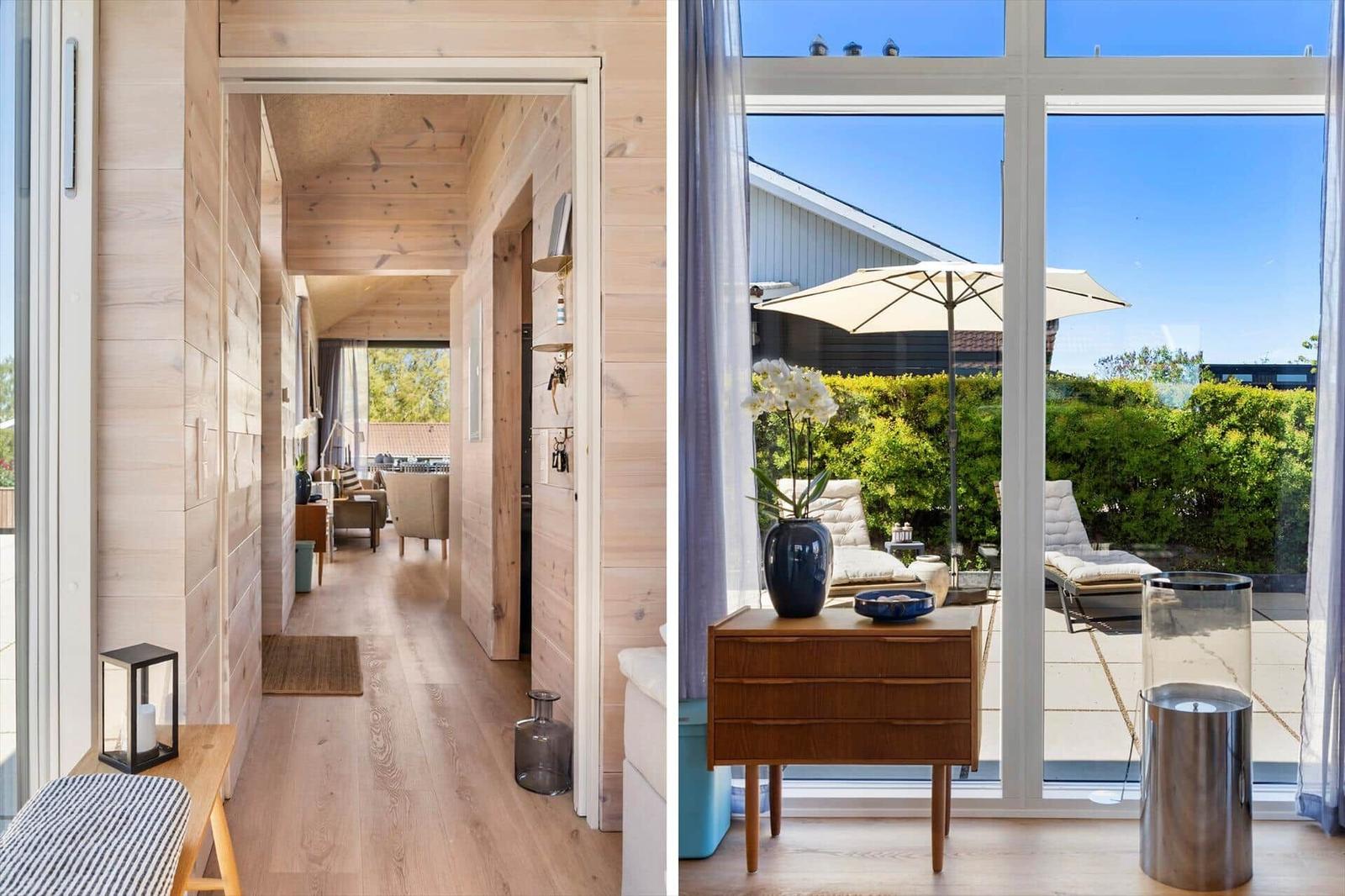 Bright wooden interiors with view of a sunny balcony with loungers and umbrella.