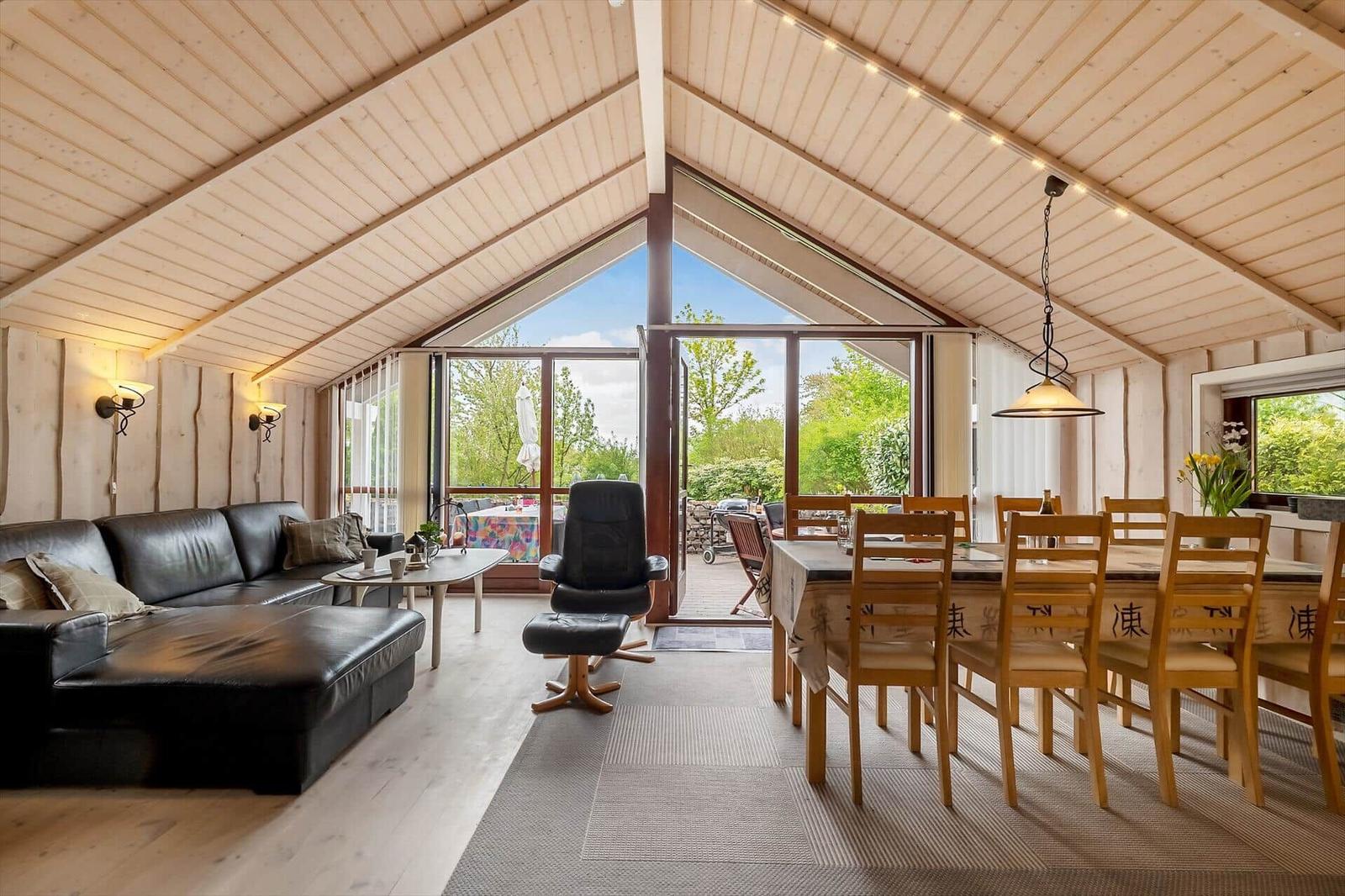 Living and dining area with seating and view of the garden.