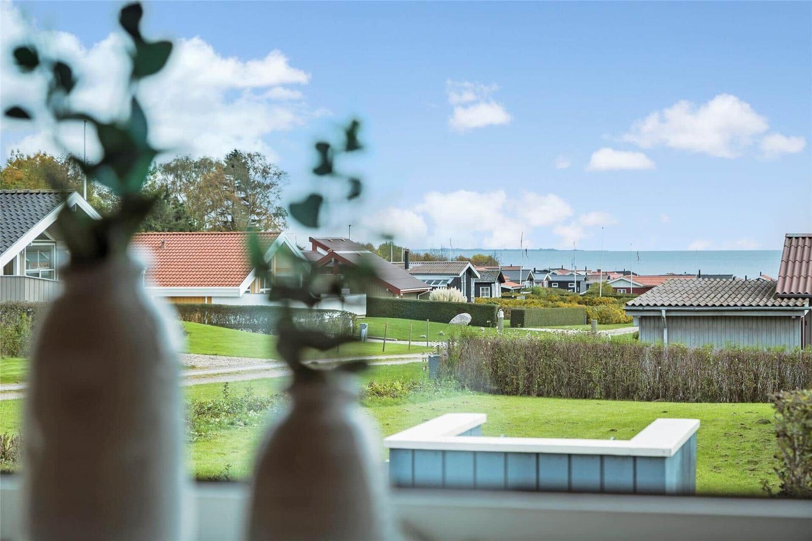 Von innen aus gesehen, Blick auf grünen Garten und Häuser am Meer.