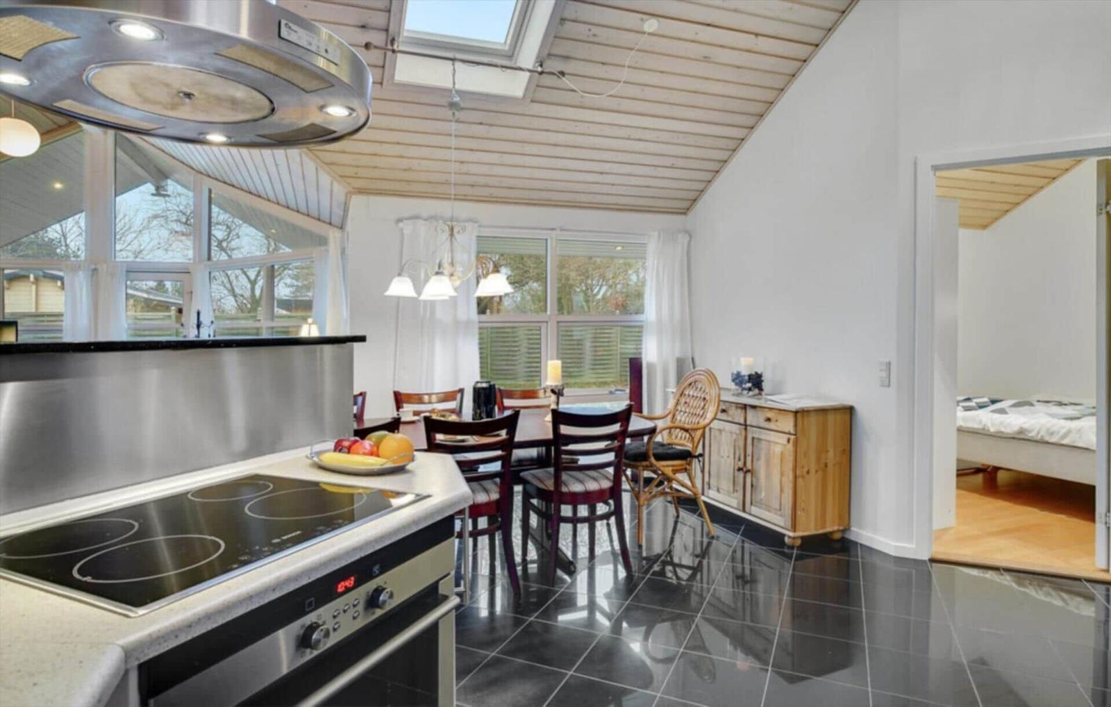 Kitchen with dining area and view into bedroom