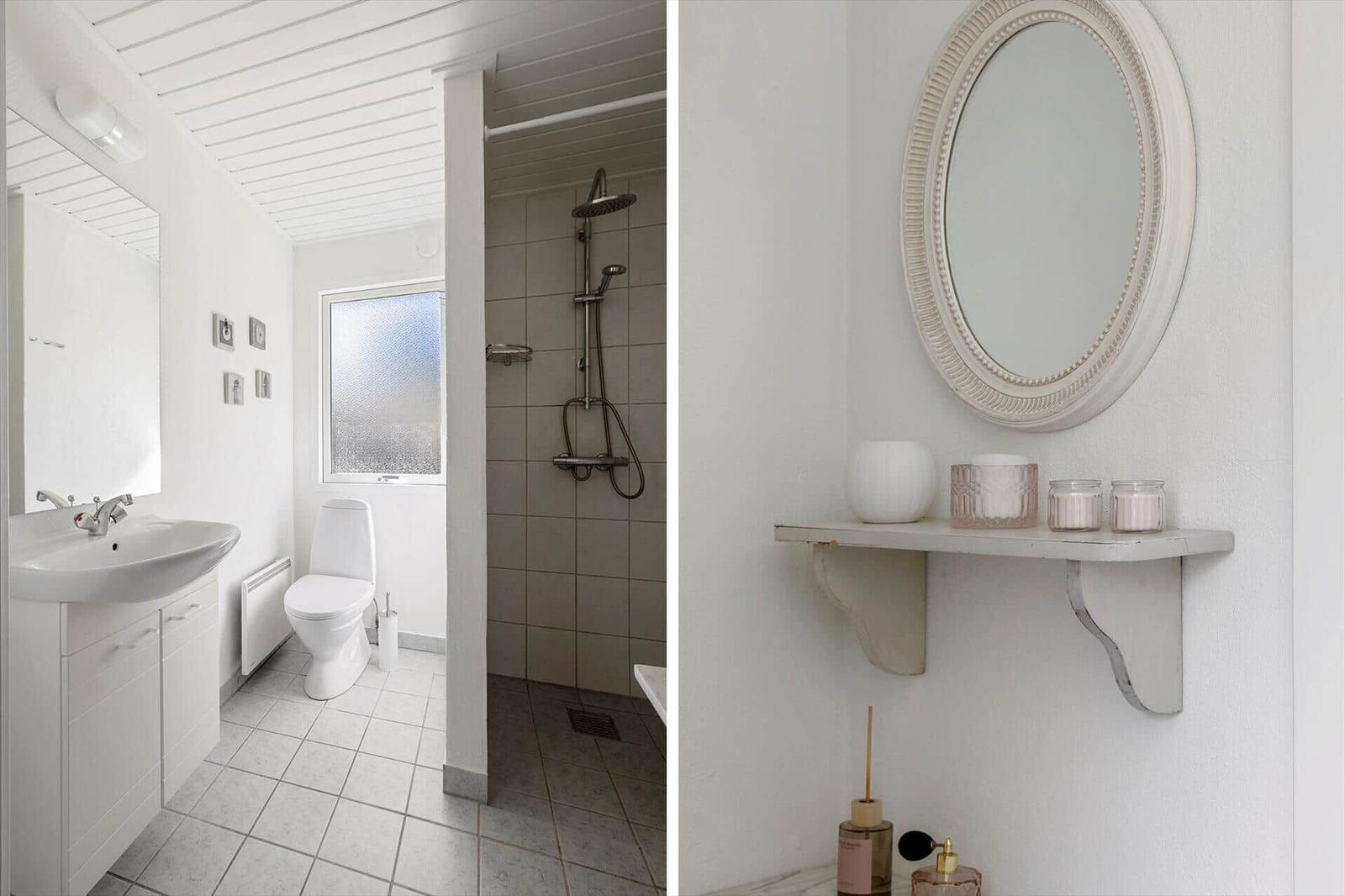Bathroom with shower, toilet, and sink. Mirror with shelf and candles.
