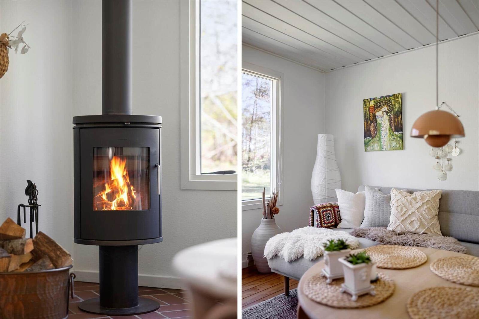 Fireplace with burning wood and living room with sofa and table