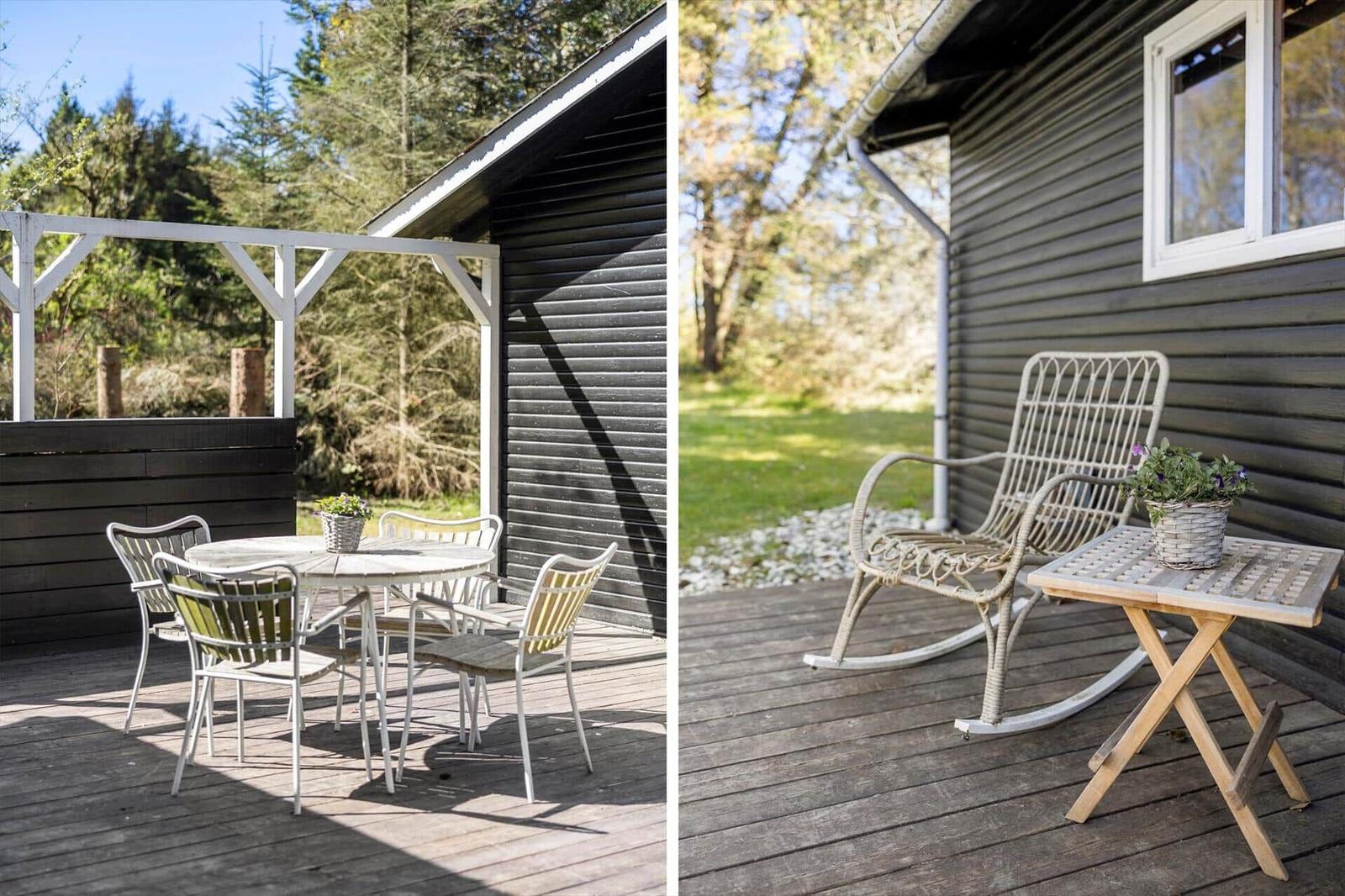 Deck with table and chairs, plus rocking chair with plant.