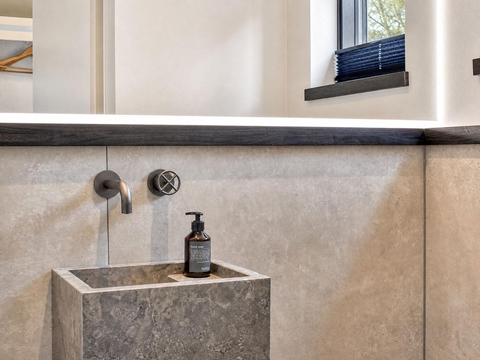 High-quality sink with faucets and soap in the bathroom