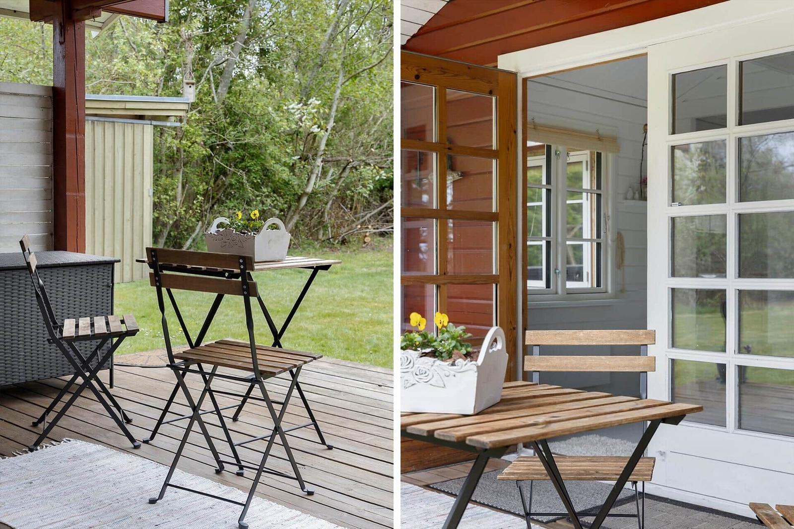 Deck with table and chairs, view of green lawn. Door leads into house.