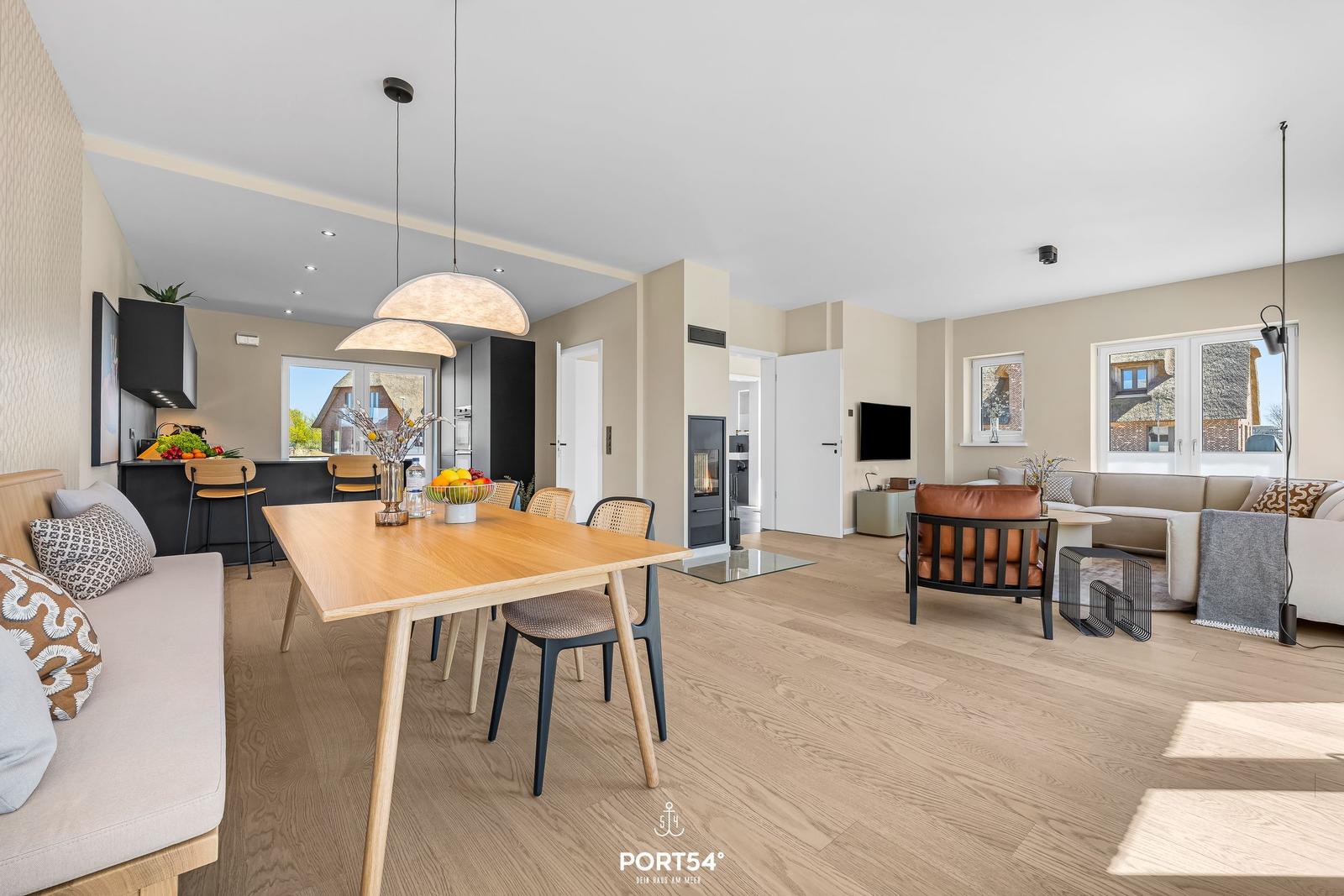 Entrance area with dining space and living room featuring hardwood flooring and modern furnishings.
