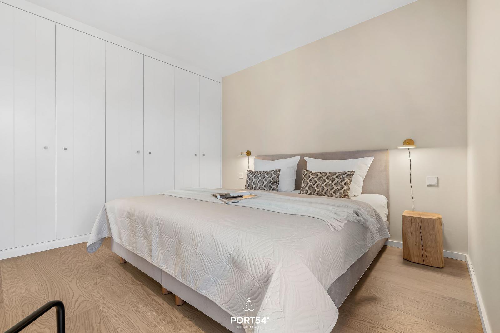 Bedroom with bed, wardrobe, and nightstand