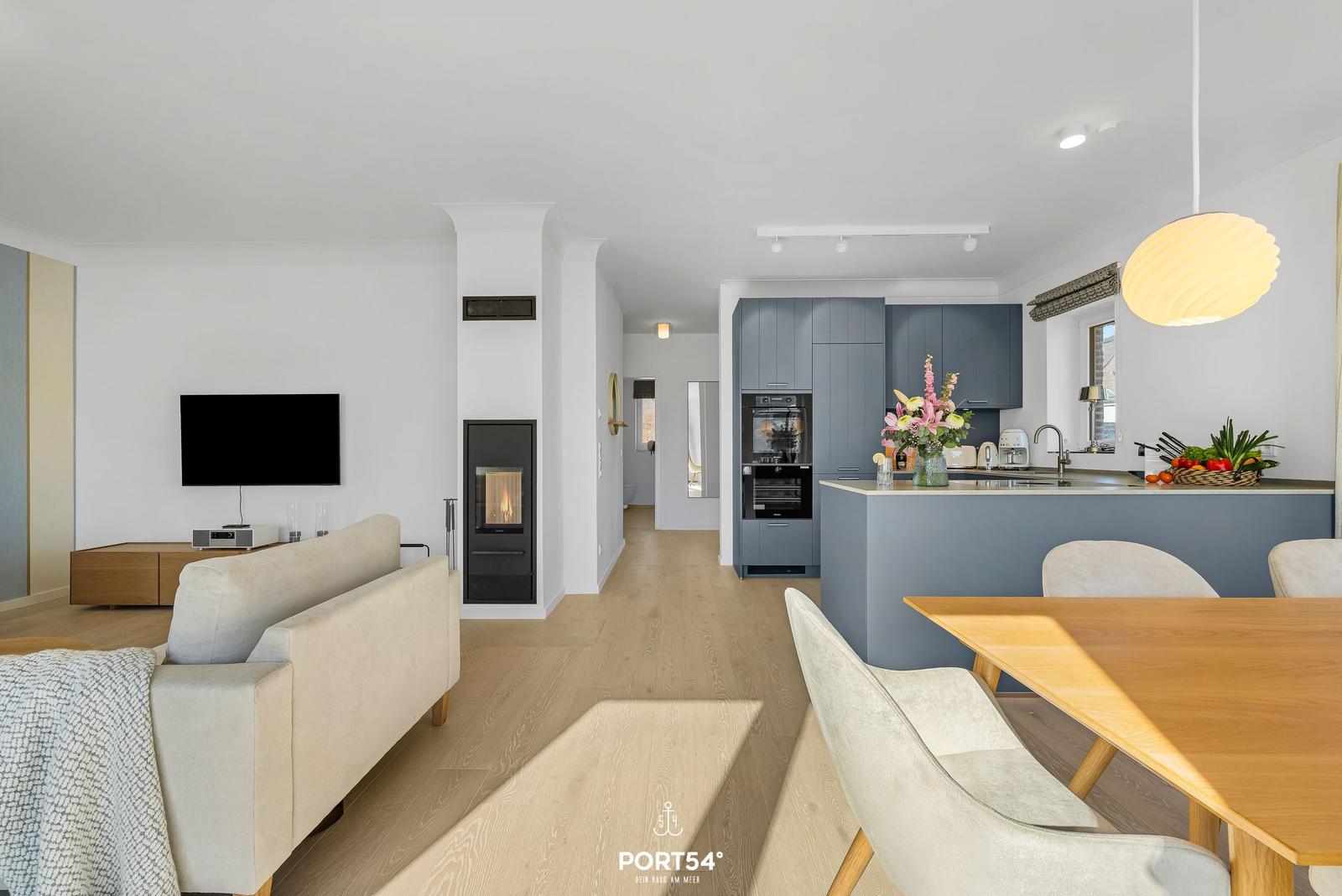 Living and dining area with kitchen island, TV, and fireplace.