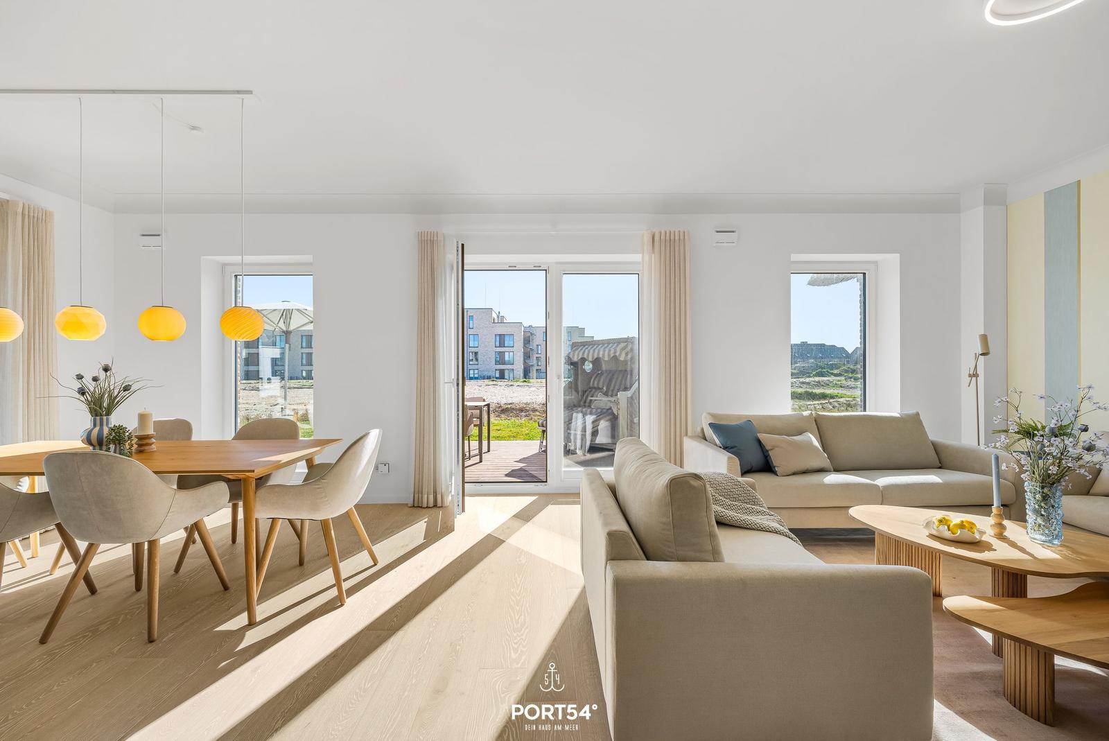 Living and dining area with view of terrace and beach.