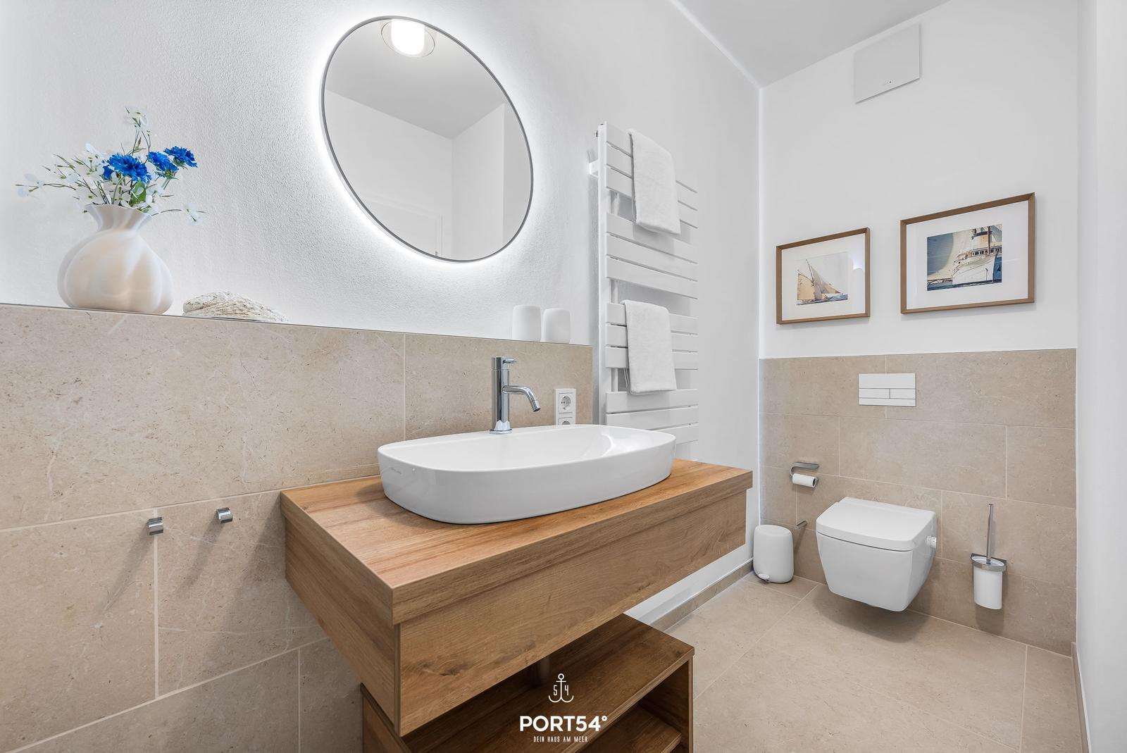 Bathroom with sink, mirror, toilet, and towel rack.