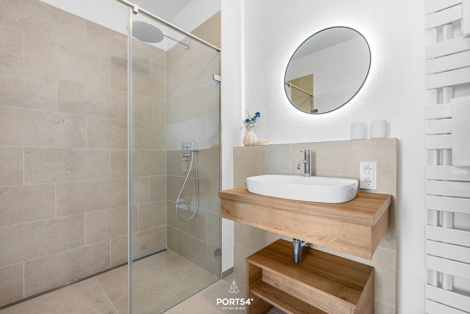 Bathroom with shower, sink, and mirror