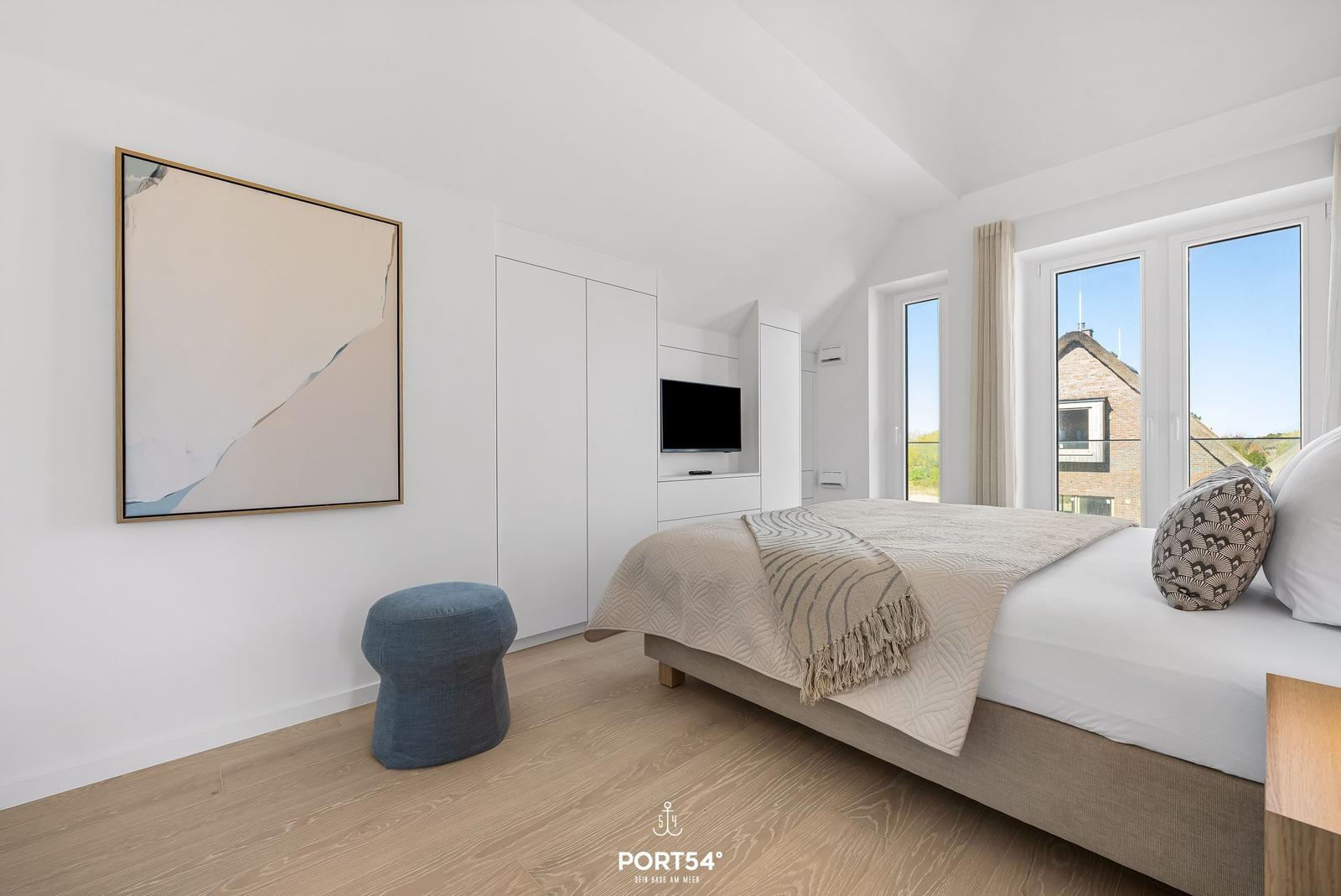Bedroom with bed, wardrobe, and window view.