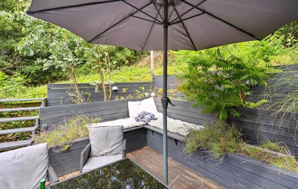 Terrace with bench, umbrella, and plants