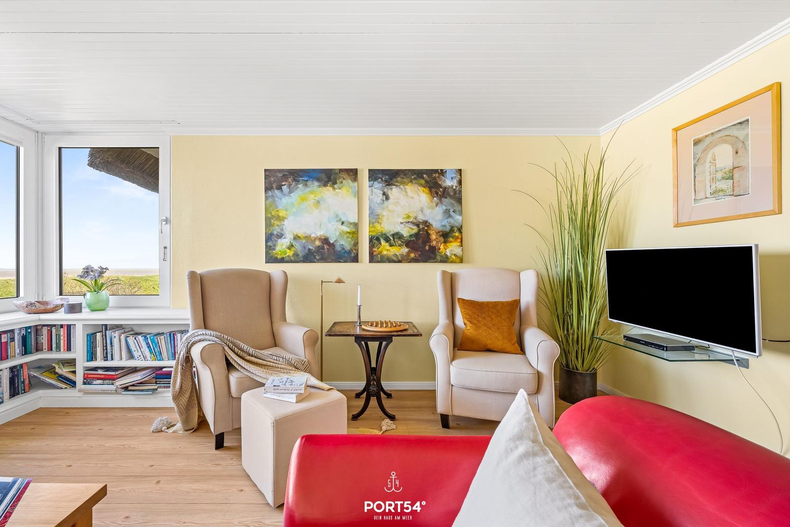 Living room with seating, TV, and view of the landscape.