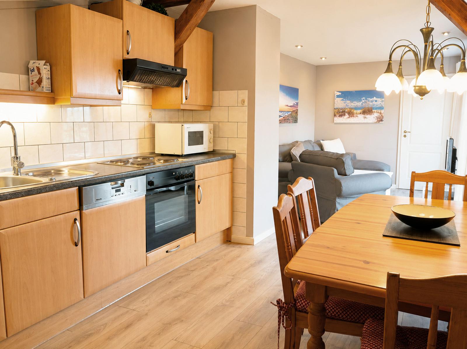 Küche mit Holzschränken und Essbereich mit Holztisch