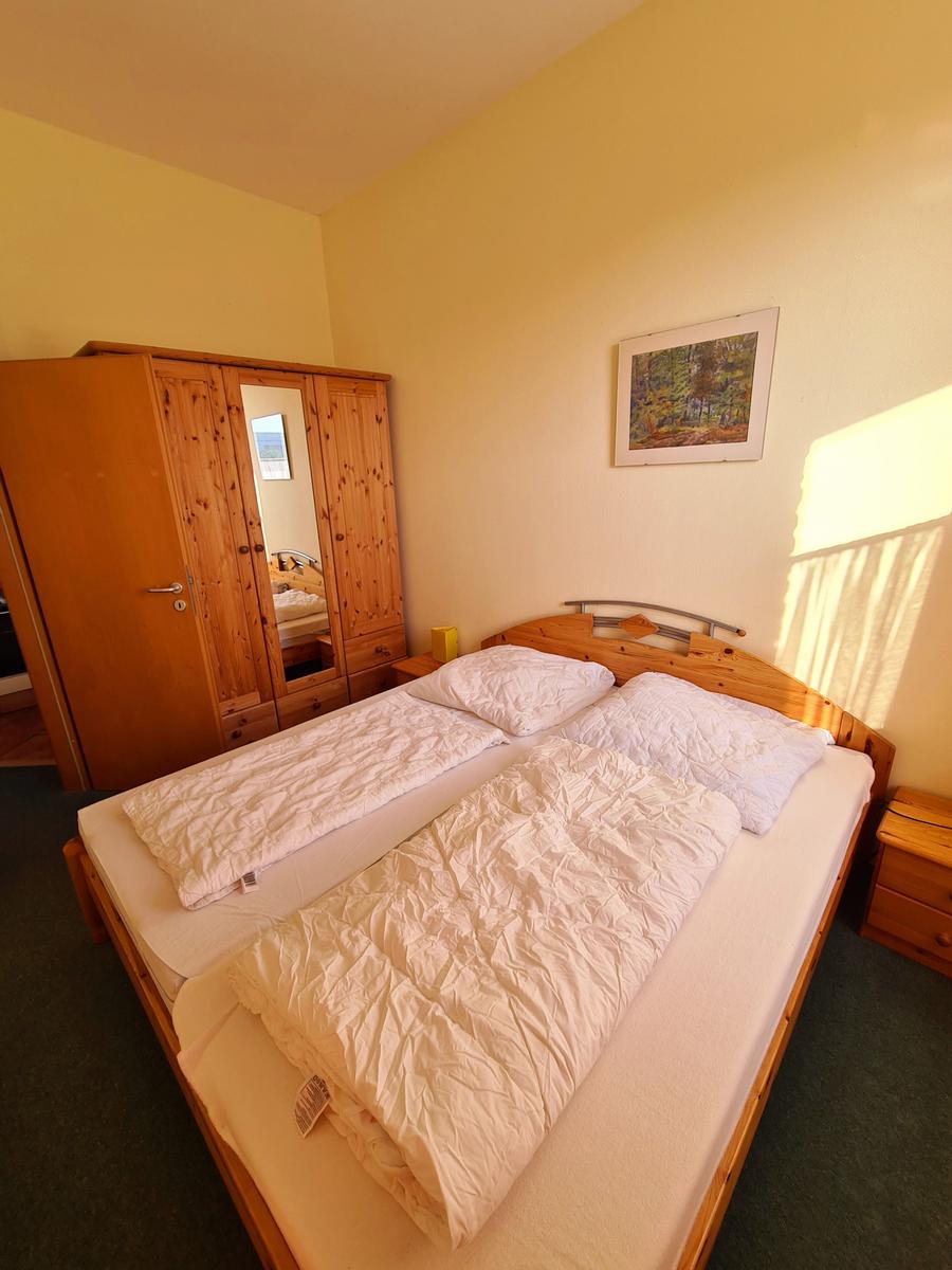 Freundliches separates Schlafzimmer mit Doppelbett in gemütlicher Ferienwohnung am Südstrand Fehmarn.