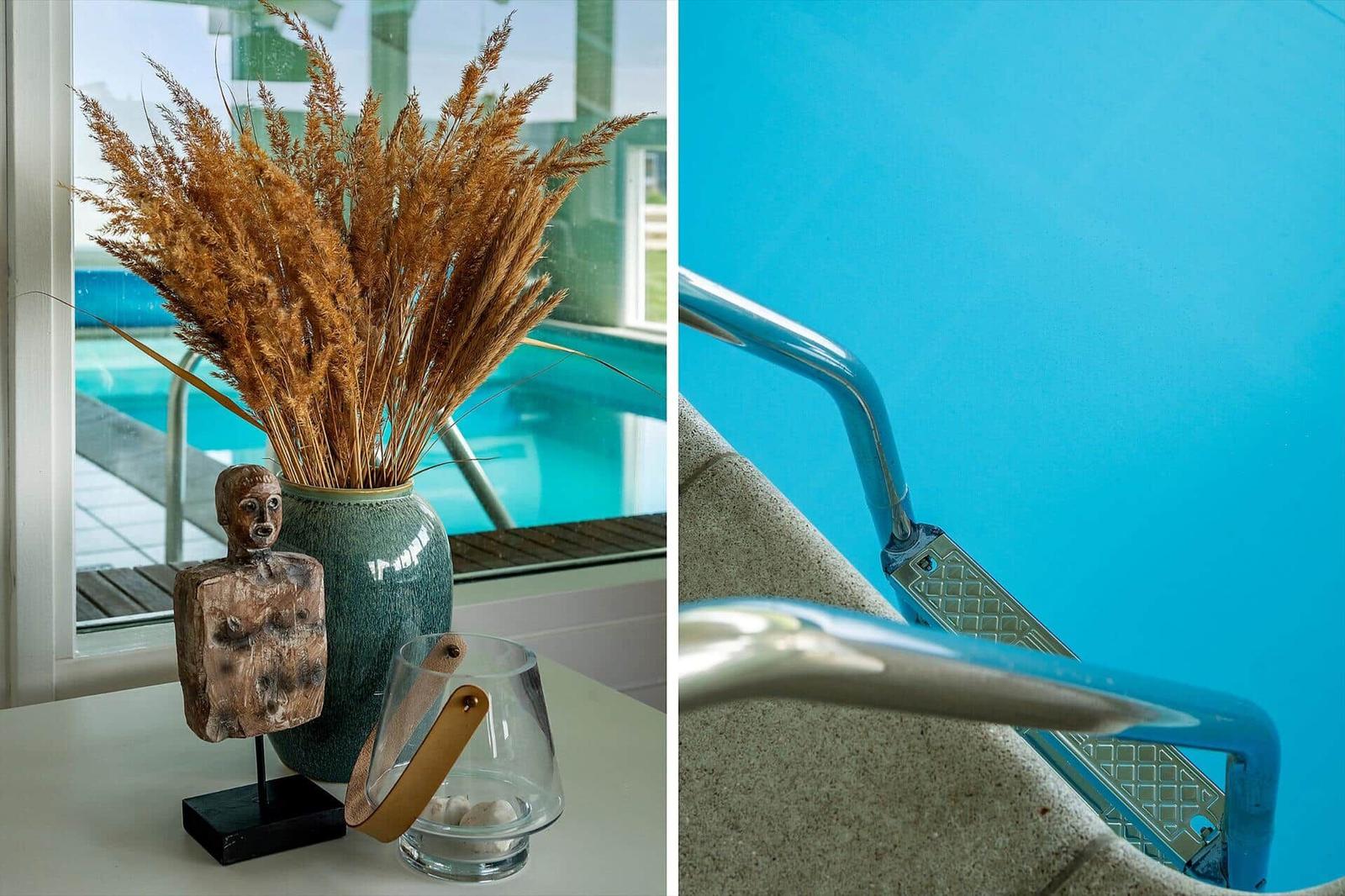 Table with vases and decor next to pool. Pool with metal steps.
