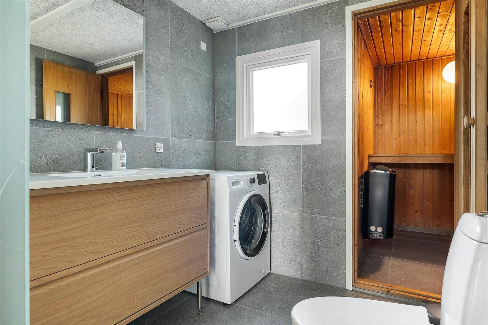 Bathroom with washing machine and sauna