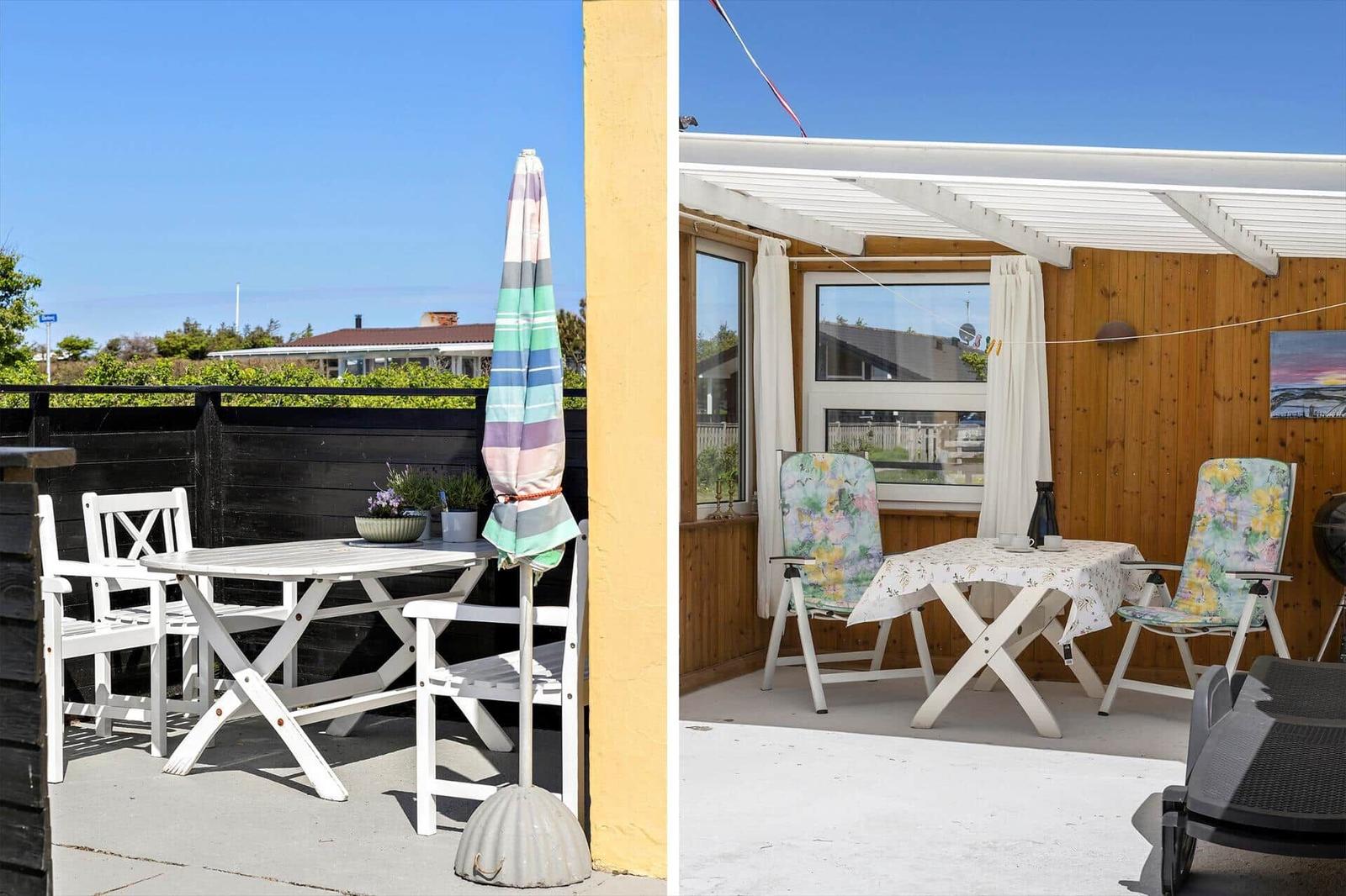 Terrace with table, chairs, and umbrella. View of garden and neighboring house.