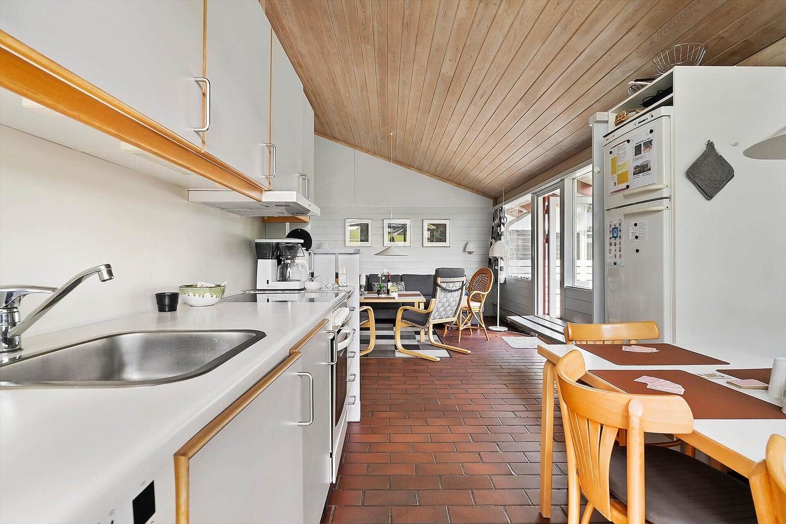 Kitchen with dining area and living room in the background.