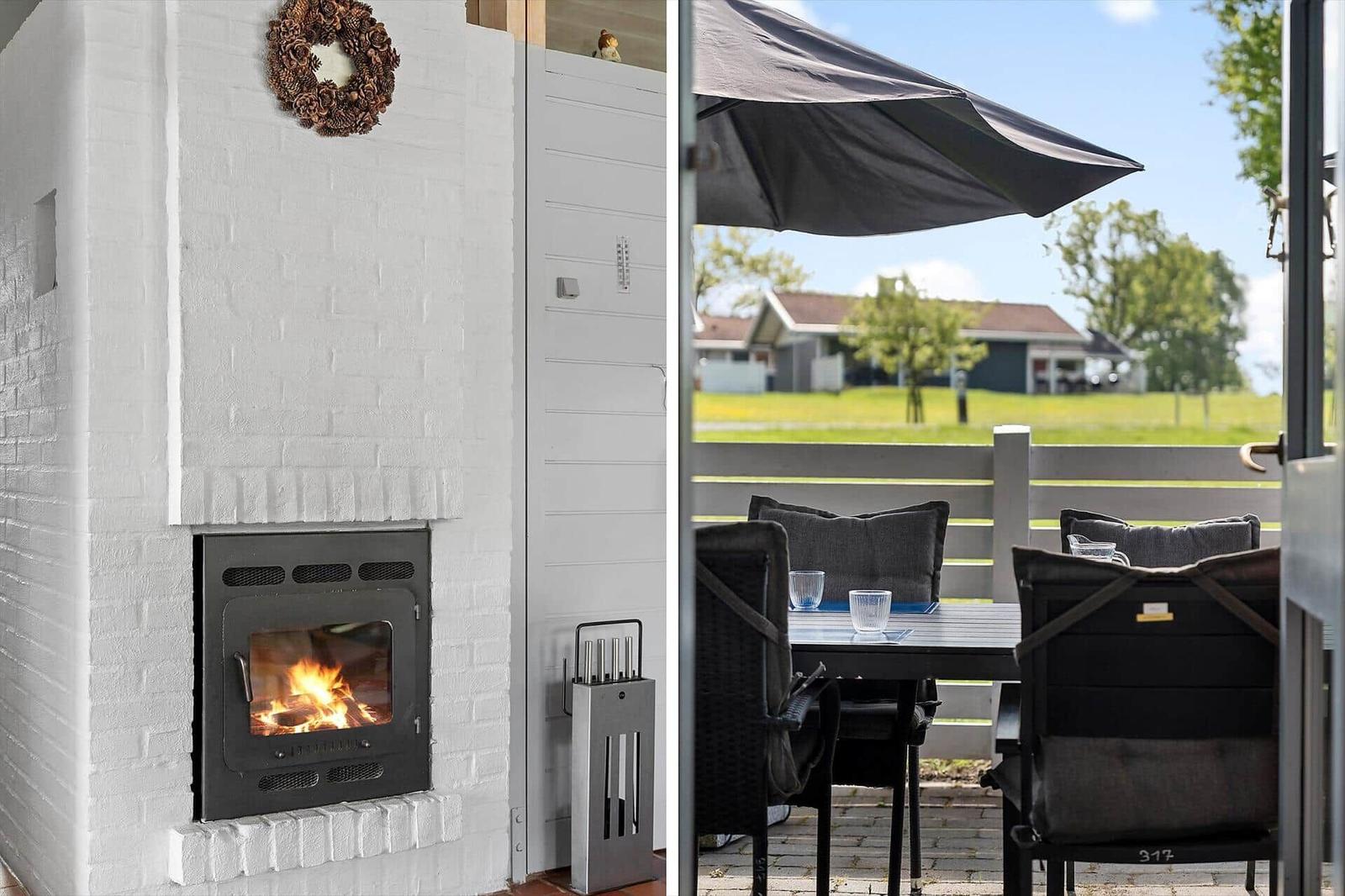 Fireplace with wood stove and outdoor terrace with table, chairs, and sun shade.