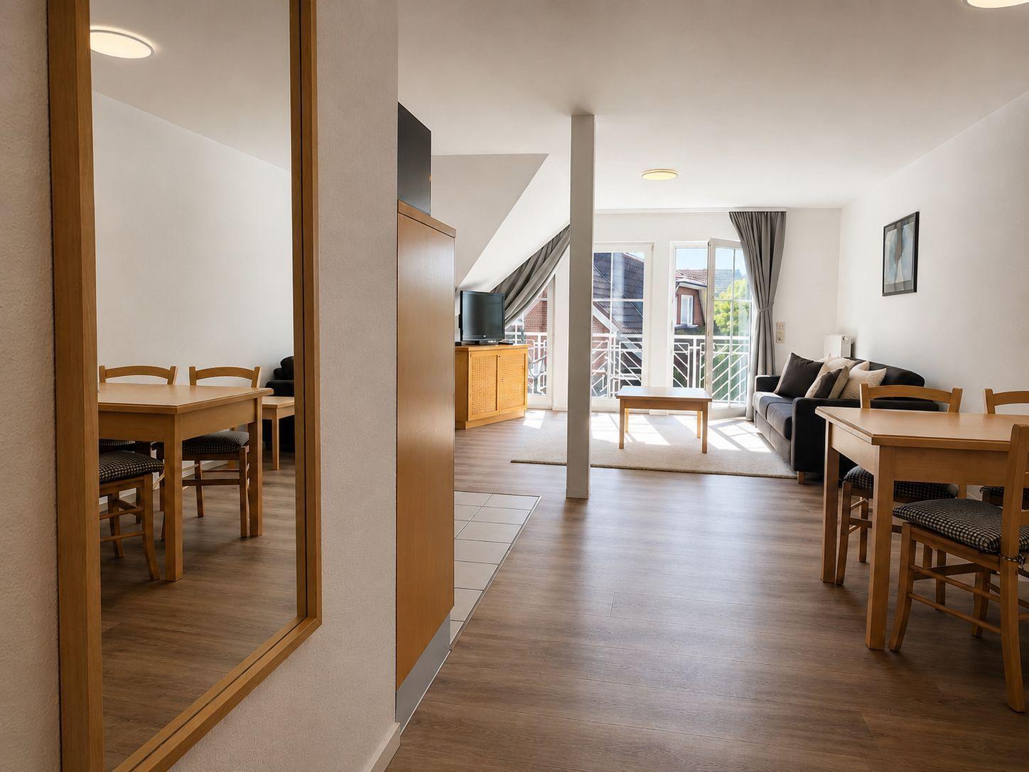 Wohnung mit Essbereich, Wohnzimmer und Balkon mit Blick auf die Umgebung.
